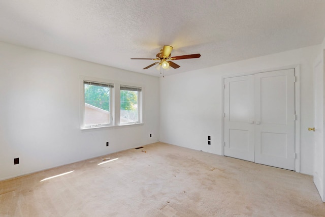 1765 38th St, Los Alamos, NM 87544 - unfurnished bedroom featuring carpet flooring, a closet, a textured ceiling, and a ceiling fan