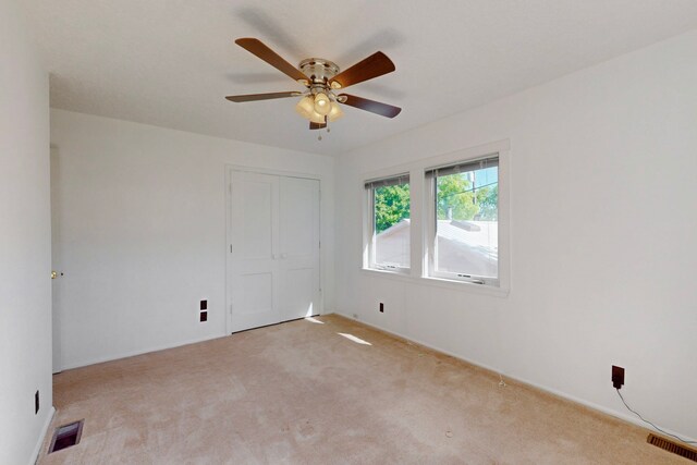 1765 38th St, Los Alamos, NM 87544 - unfurnished bedroom with light colored carpet, a closet, a ceiling fan, and baseboards