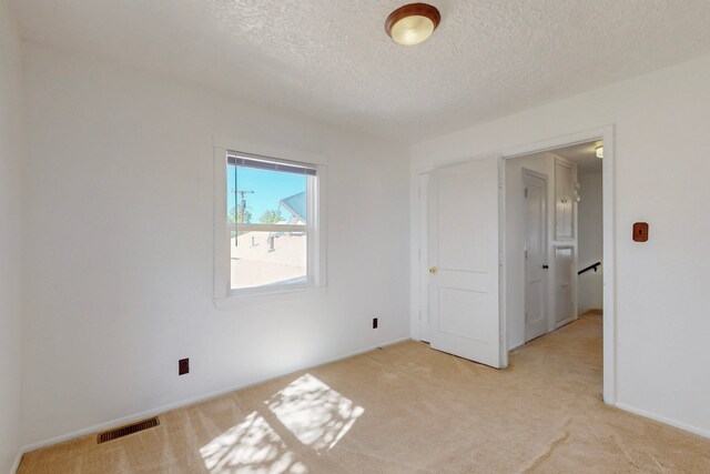 1765 38th St, Los Alamos, NM 87544 - unfurnished room featuring a textured ceiling, light colored carpet, and baseboards