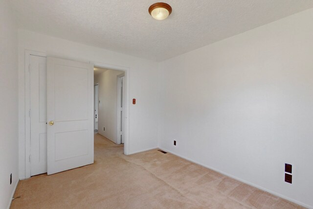 1765 38th St, Los Alamos, NM 87544 - spare room with light carpet, a textured ceiling, and baseboards