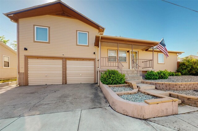 1765 38th St, Los Alamos, NM 87544 - view of front facade featuring an attached garage, asphalt driveway, and covered porch