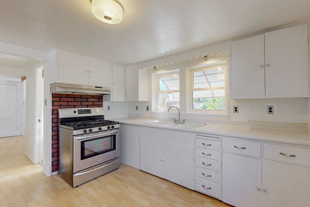 1765 38th St, Los Alamos, NM 87544 - kitchen featuring stainless steel range with gas cooktop, under cabinet range hood, a sink, and white cabinets