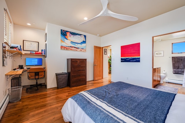 543 Juanita Unit B, Santa Fe, NM 87501 - bedroom featuring wood finished floors, a baseboard heating unit, a desk, ensuite bath, and recessed lighting