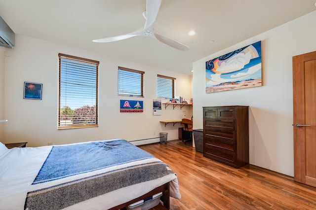 543 Juanita Unit B, Santa Fe, NM 87501 - bedroom featuring light wood finished floors, baseboard heating, a ceiling fan, a wall unit AC, and recessed lighting