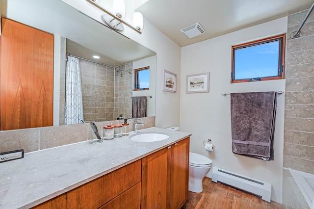 543 Juanita Unit B, Santa Fe, NM 87501 - full bath featuring a baseboard radiator, toilet, vanity, and curtained shower