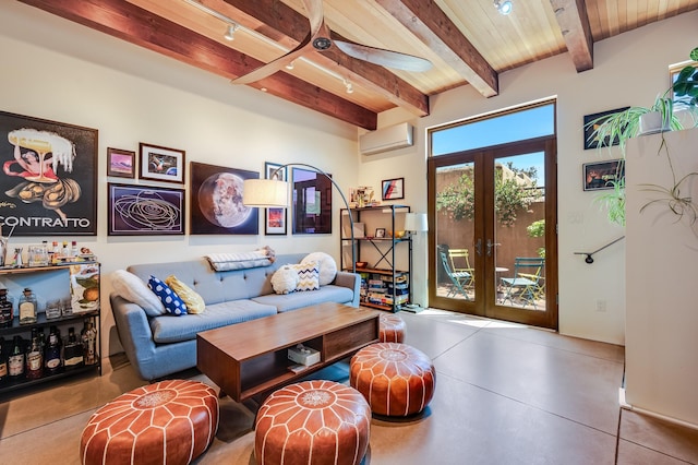 543 Juanita Unit B, Santa Fe, NM 87501 - living area featuring an AC wall unit, french doors, ceiling fan, concrete flooring, and wooden ceiling with exposed beams