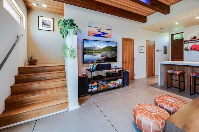 543 Juanita Unit B, Santa Fe, NM 87501 - living room featuring beam ceiling, stairs, and finished concrete floors