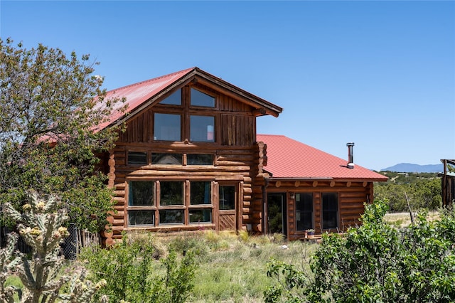 208A Camino Los Abuelos, Santa Fe, NM 87508 - back of property with log siding, metal roof, and a mountain view
