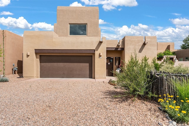 11 W Avenida Sebastian, Santa Fe, NM 87506 - pueblo-style home with driveway, stucco siding, and an attached garage