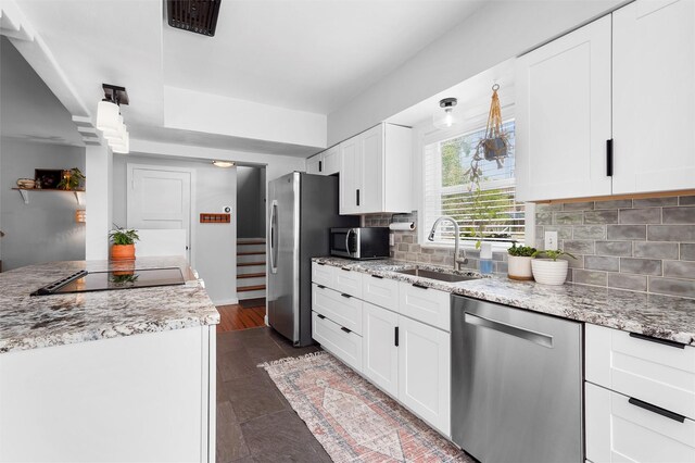 3177 Nickel Unit A, Los Alamos, NM 87544 - kitchen featuring stainless steel appliances, a sink, decorative backsplash, white cabinets, and light stone counters
