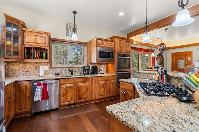 50 Jackson Hole Rd, Angel Fire, NM 87710 - kitchen featuring appliances with stainless steel finishes, brown cabinets, healthy amount of natural light, beamed ceiling, and a sink