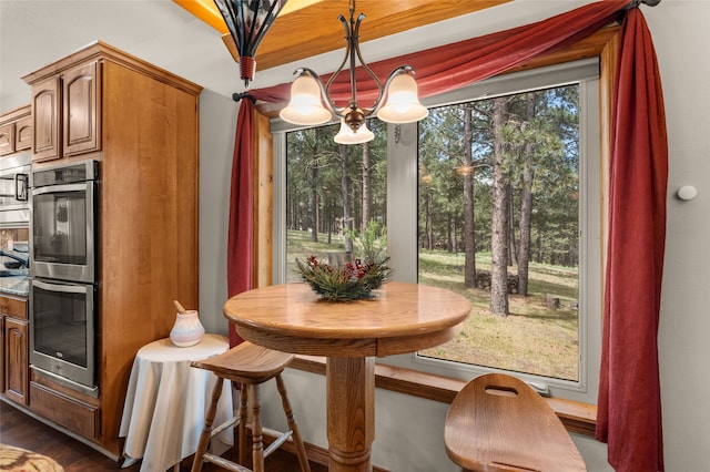 50 Jackson Hole Rd, Angel Fire, NM 87710 - dining room with a chandelier and dark wood-style floors