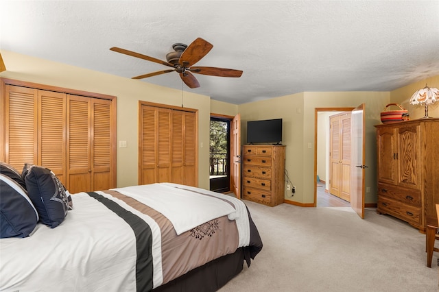 50 Jackson Hole Rd, Angel Fire, NM 87710 - bedroom with multiple closets, a textured ceiling, ceiling fan, light colored carpet, and baseboards