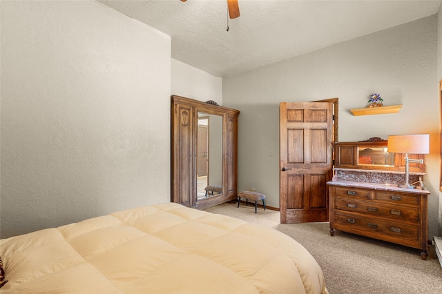 50 Jackson Hole Rd, Angel Fire, NM 87710 - bedroom featuring light carpet, lofted ceiling, a ceiling fan, a textured ceiling, and a textured wall
