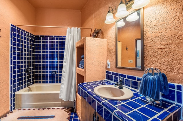 50 Jackson Hole Rd, Angel Fire, NM 87710 - full bathroom with a textured wall, shower / bathtub combination with curtain, and vanity