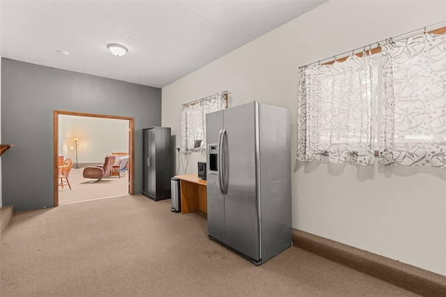 50 Jackson Hole Rd, Angel Fire, NM 87710 - kitchen featuring stainless steel refrigerator with ice dispenser, light colored carpet, and light countertops
