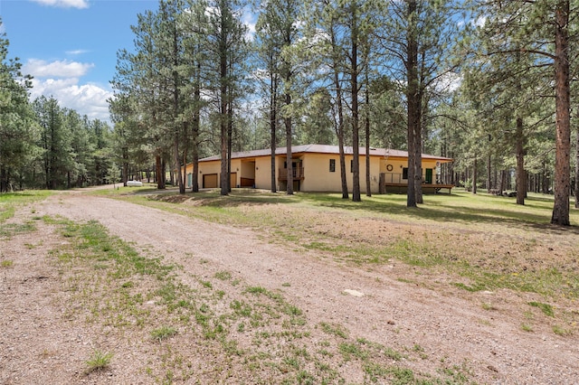 50 Jackson Hole Rd, Angel Fire, NM 87710 - view of front of home with stucco siding and driveway