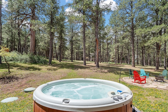 50 Jackson Hole Rd, Angel Fire, NM 87710 - view of yard with a hot tub, a fire pit, and a view of trees