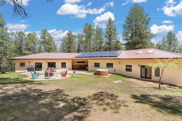 50 Jackson Hole Rd, Angel Fire, NM 87710 - back of house featuring french doors, stucco siding, a patio area, solar panels, and metal roof