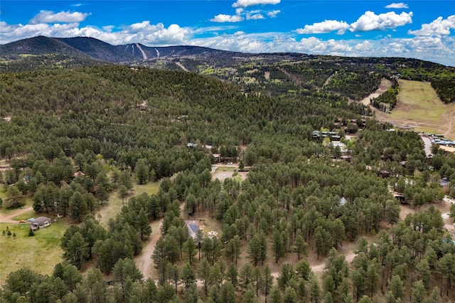 50 Jackson Hole Rd, Angel Fire, NM 87710 - aerial overview of property's location with a heavily wooded area and a mountain backdrop