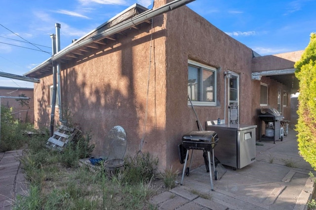1619 Brae St, Santa Fe, NM 87505 - view of home's exterior featuring stucco siding and a patio area