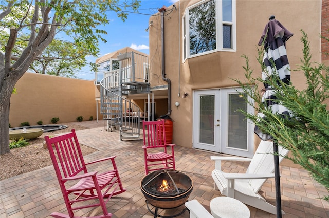 309 Lomita St, Santa Fe, NM 87505 - view of patio with a fire pit, stairs, french doors, and a deck