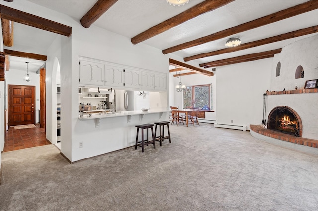 1905 Camino Redondo, Los Alamos, NM 87544 - carpeted living room featuring a baseboard radiator, beam ceiling, a fireplace, and baseboards