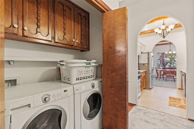 1905 Camino Redondo, Los Alamos, NM 87544 - laundry room featuring cabinet space, a chandelier, washer and clothes dryer, light carpet, and arched walkways