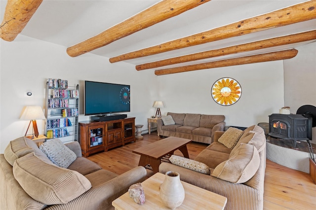 1905 Camino Redondo, Los Alamos, NM 87544 - living area featuring a wood stove, beam ceiling, light wood-style flooring, and a baseboard radiator