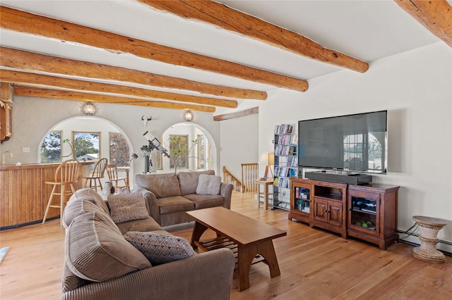 1905 Camino Redondo, Los Alamos, NM 87544 - living area with beam ceiling, wood finished floors, bar with sink, and arched walkways