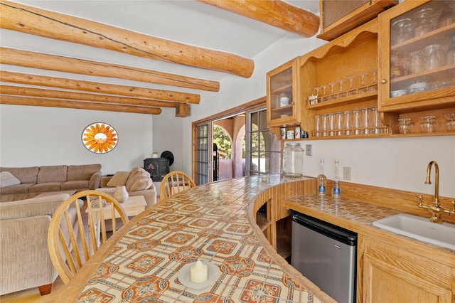 1905 Camino Redondo, Los Alamos, NM 87544 - kitchen with a sink, beamed ceiling, glass insert cabinets, fridge, and open floor plan