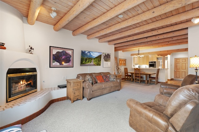 3101 Old Pecos Trl Unit 101, Santa Fe, NM 87505 - carpeted living area with wood ceiling with exposed beams, a fireplace, a chandelier, and baseboards