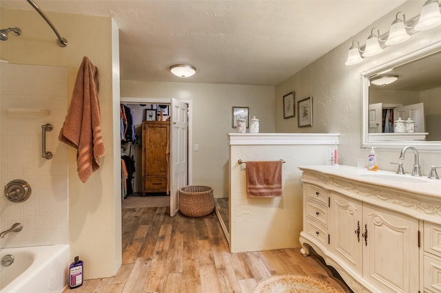 133 County Rd 135, Hernandez, NM 87537 - full bath with vanity, wood finished floors, and tub / shower combination