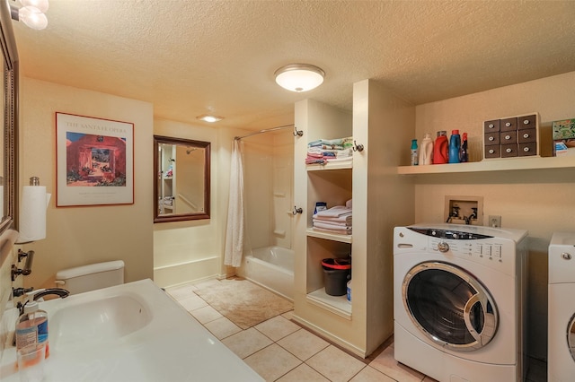 133 County Rd 135, Hernandez, NM 87537 - laundry room with light tile patterned floors, a textured ceiling, and washing machine and dryer