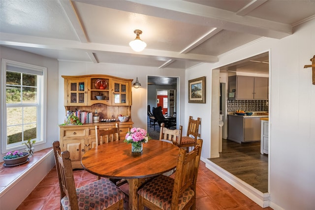 133 County Rd 135, Hernandez, NM 87537 - dining space with beam ceiling and dark tile patterned floors
