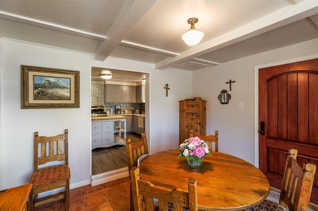 133 County Rd 135, Hernandez, NM 87537 - dining space featuring beamed ceiling and dark tile patterned flooring