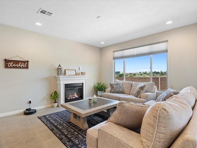 5220 Gold Hill Ln, Santa Fe, NM 87507 - living area featuring baseboards, a glass covered fireplace, recessed lighting, light tile patterned flooring, and a textured ceiling