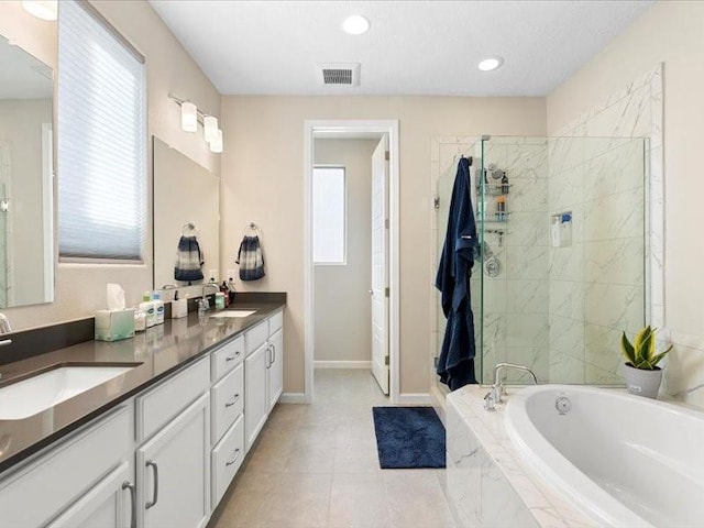 5220 Gold Hill Ln, Santa Fe, NM 87507 - bathroom featuring a garden tub, double vanity, tiled shower, baseboards, and tile patterned flooring