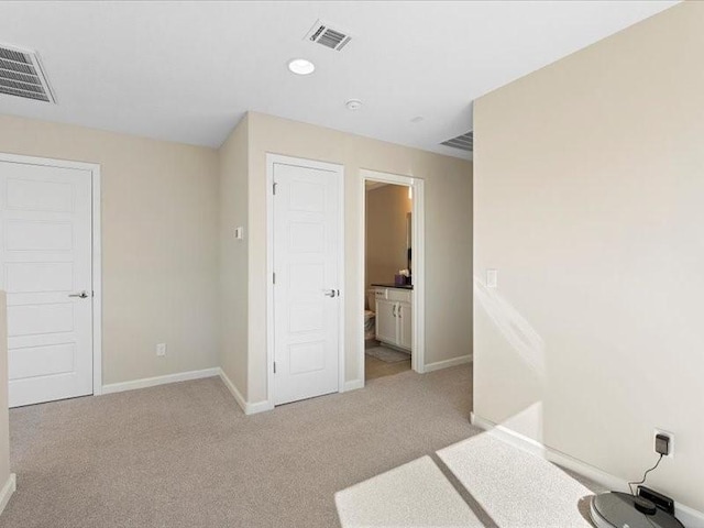 5220 Gold Hill Ln, Santa Fe, NM 87507 - unfurnished bedroom featuring baseboards, light colored carpet, and ensuite bathroom