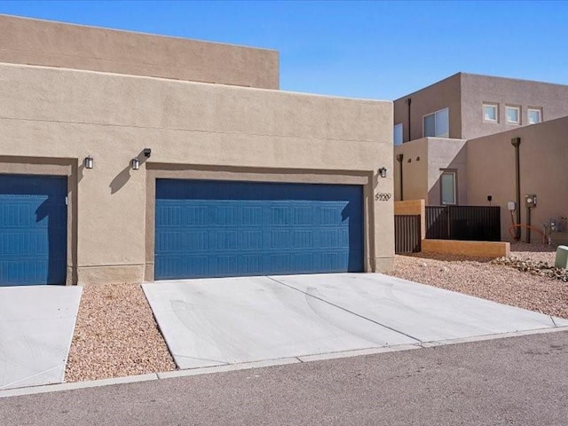 5220 Gold Hill Ln, Santa Fe, NM 87507 - pueblo revival-style home with stucco siding and driveway