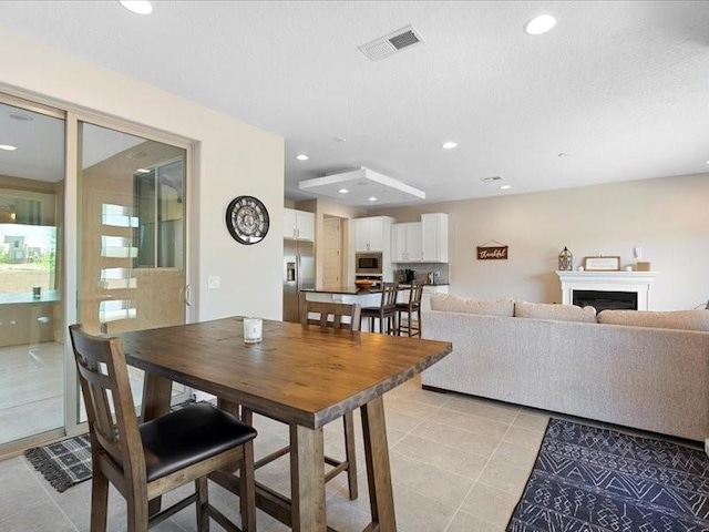 5220 Gold Hill Ln, Santa Fe, NM 87507 - dining room featuring light tile patterned flooring, recessed lighting, and a fireplace