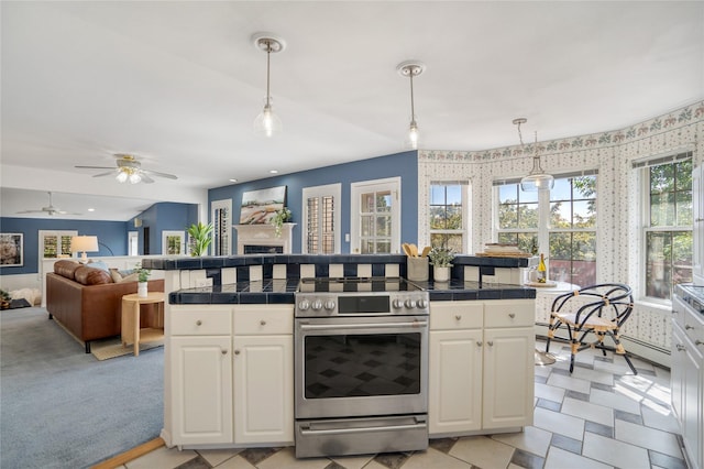 917 Estates Dr, Los Alamos, NM 87544 - kitchen featuring stainless steel electric stove, tile countertops, and white cabinets