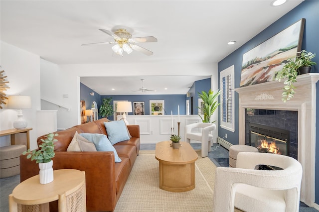 917 Estates Dr, Los Alamos, NM 87544 - living area featuring baseboard heating, a ceiling fan, a tiled fireplace, recessed lighting, and carpet floors