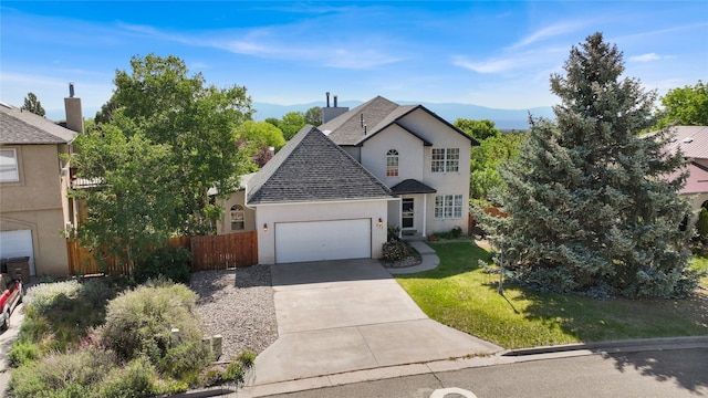 917 Estates Dr, Los Alamos, NM 87544 - view of front facade featuring stucco siding, a garage, roof with shingles, driveway, and a mountain view