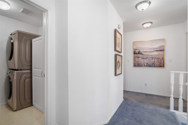 917 Estates Dr, Los Alamos, NM 87544 - hall with stacked washer and clothes dryer, baseboards, and light carpet