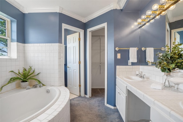 917 Estates Dr, Los Alamos, NM 87544 - bathroom featuring double vanity, a garden tub, crown molding, a walk in closet, and baseboards
