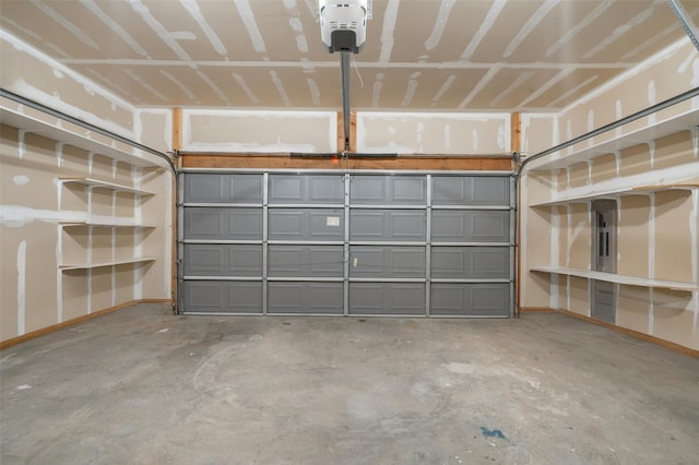917 Estates Dr, Los Alamos, NM 87544 - garage featuring a garage door opener and baseboards