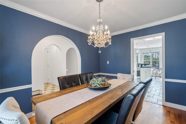 917 Estates Dr, Los Alamos, NM 87544 - dining area featuring baseboard heating, a chandelier, baseboards, wood finished floors, and crown molding