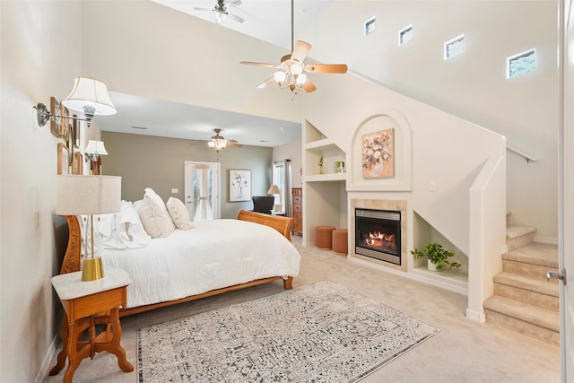 1810 Eucalyptus Rd NE, Rio Rancho, NM 87144 - bedroom with a high ceiling, carpet, a tile fireplace, baseboards, and ceiling fan