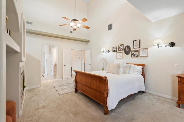 1810 Eucalyptus Rd NE, Rio Rancho, NM 87144 - bedroom featuring arched walkways, light carpet, baseboards, a towering ceiling, and ceiling fan